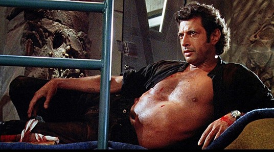 Reclining shirtless Jeff Goldblum
