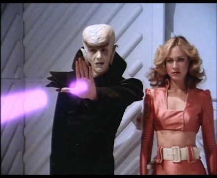 A space vampire, projecting a bolt of energy from his hand, stands with Wilma Deering.