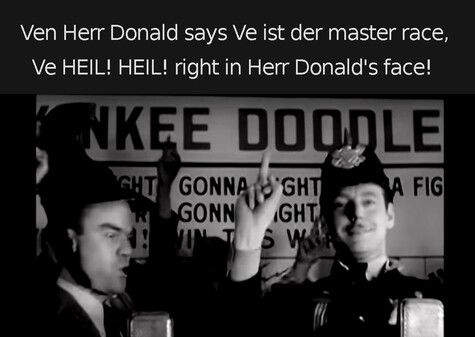 This video still is from Spike Jones' band performing "In Der Fuehrer's Face" with soloist Carl Grayson holding up his middle finger. Caption: "Ven Herr Donald says Ve ist der master race, Ve HEIL! HEIL! right in Herr Donald's face!